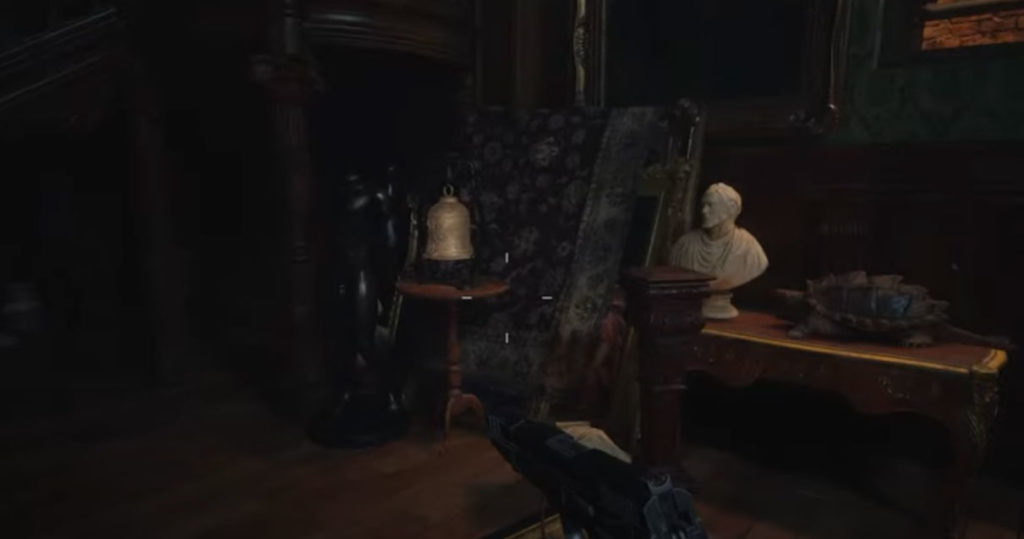 How to solve the five bells puzzle in Resident Evil Village - Bell on the table