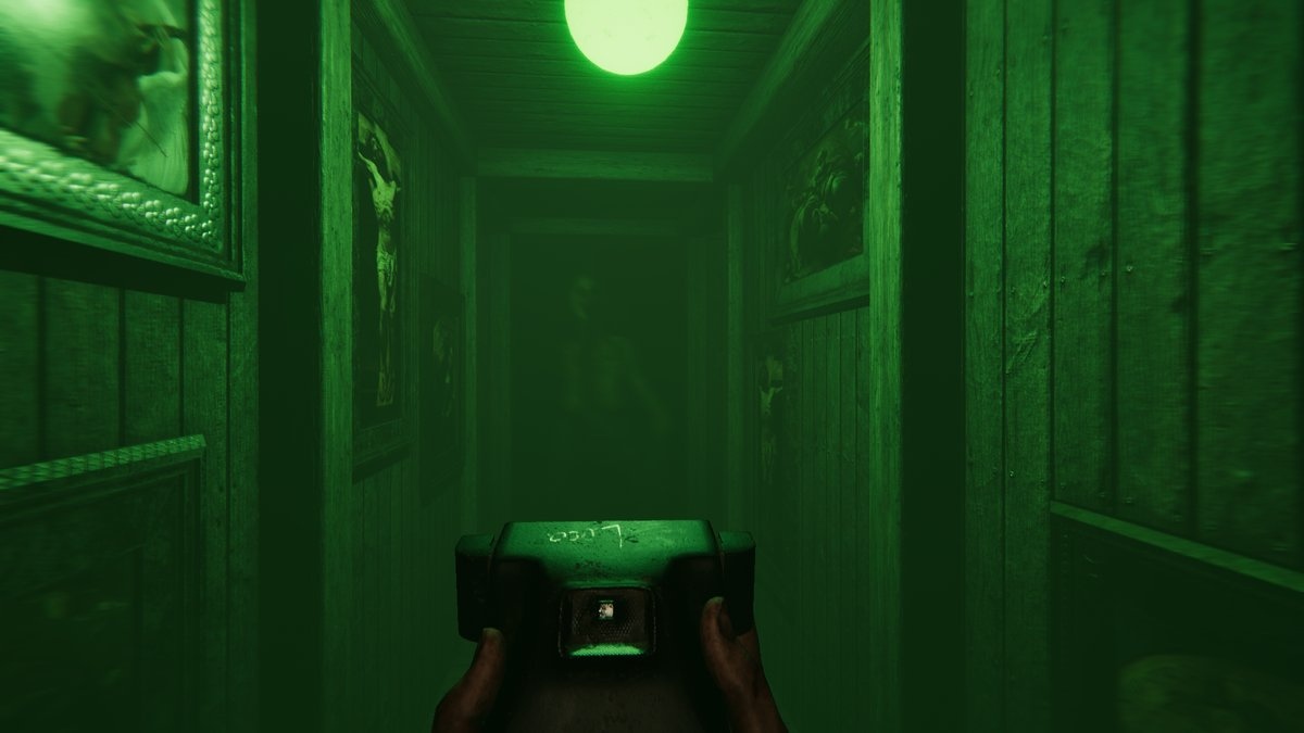 A camera navigates a green-lit hallway