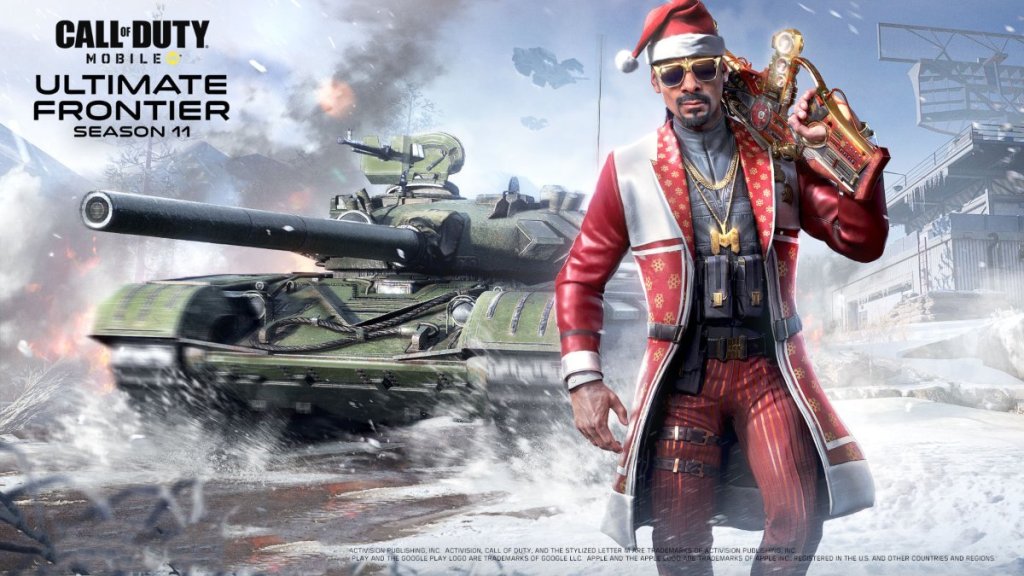 Snoop Dogg standing in front of a tank while dressed as Santa